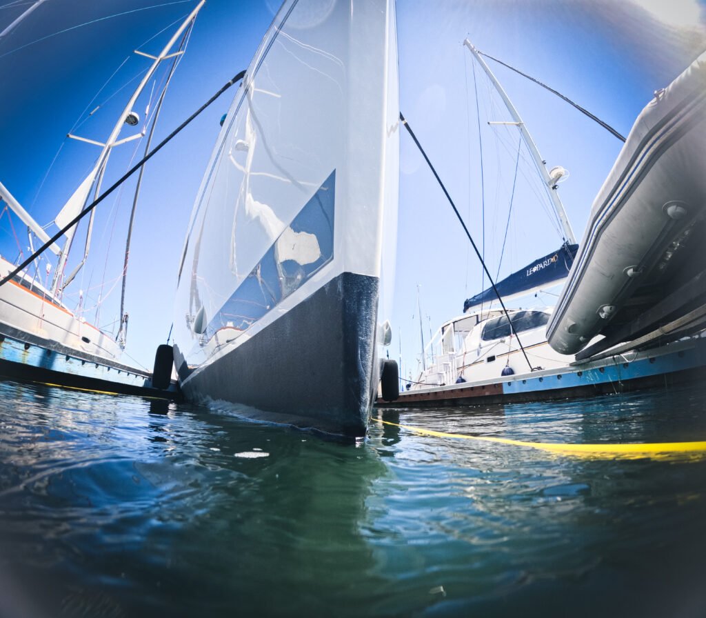 Sailboat hull before underwater cleaning at a California marina