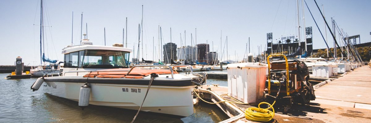 Professional boat diver preparing for underwater hull cleaning at marina