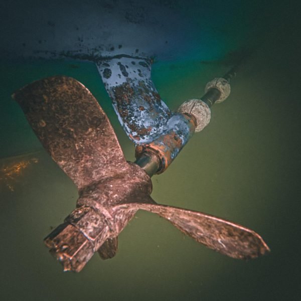 Boat propeller, shaft and zinc anodes during underwater inspection and cleaning